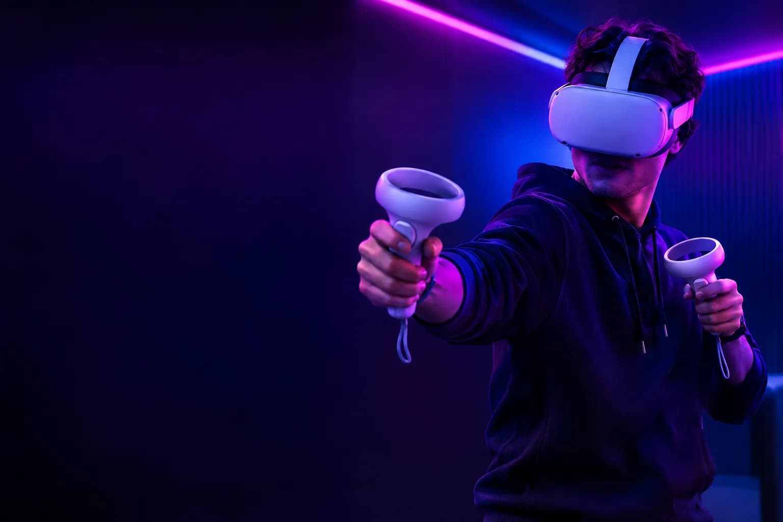 A player wearing a VR headset and holding two motion controllers